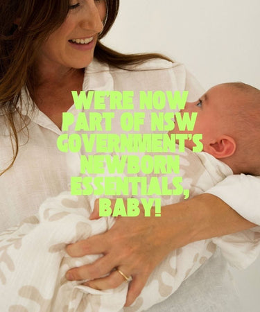 Woman holding a baby with text overlay about newborn essentials in New South Wales.